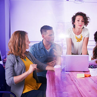 Collegues sitting before a laptop