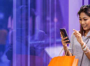 Woman on phone while shopping