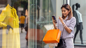 Woman on phone while shopping