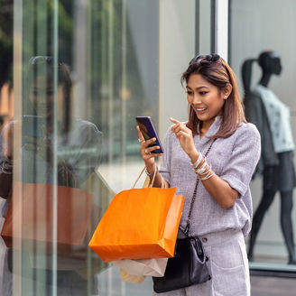 Woman on phone while shopping