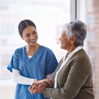 Nurse holding hands of old patient