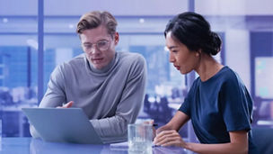 A man and woman working together on a laptop