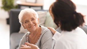 Old age women looking at doctor