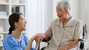 Young Asian woman, nurse, caregiver, carer of nursing home talking with senior Asian woman feeling happy at home