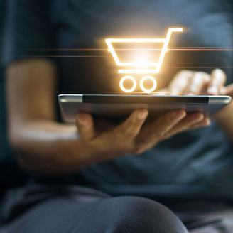 Online shopping and digital marketing concept, Woman using digital tablet with shopping cart icon on screen on dark background.