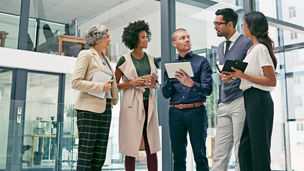 Business is built on a solid foundation of relationships. Shot of a group of colleagues having an informal meeting in an office.