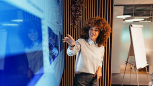 A person with an afro looking at a screen