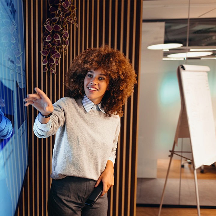 A person with an afro looking at a screen