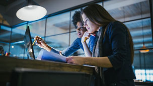 People looking at a laptop