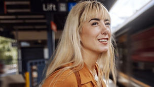 Woman waiting on a platform for a train