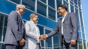 Indian Businessmen Shaking Hands Outside Office Building After Successful Deal