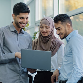 Multiethnic colleagues listens Arabic team leader explain corporate task application to diverse workers indian businesspeople looking on laptop screen working together, teamwork brainstorm concept. High quality photo