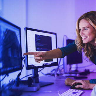A woman and a man looking at the screen
