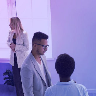 People in a room having a discussion banner