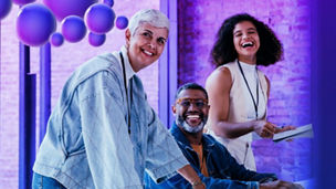 Three collegues laughing at office