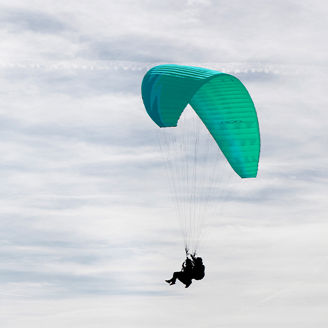 People on green paraglider