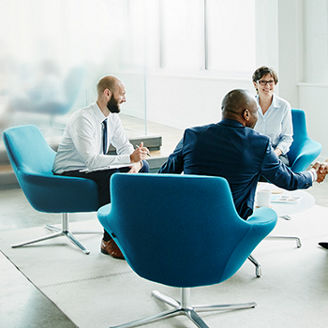 People sitting in blue chairs having a meeting banner