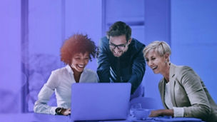 People smiling looking at laptop