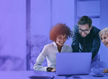 People smiling looking at laptop