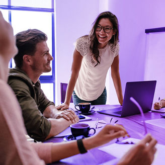 Woman in office with smiling coworkers