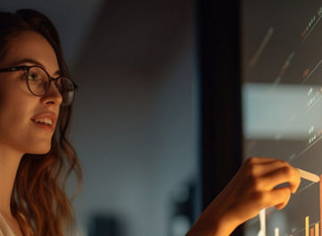 A person looking at data on a board in a dark room