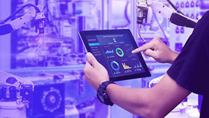 person in robotic lab with tablet banner