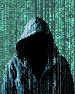 dark figure in front of a green matrix