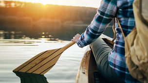 Person paddling boat in lake