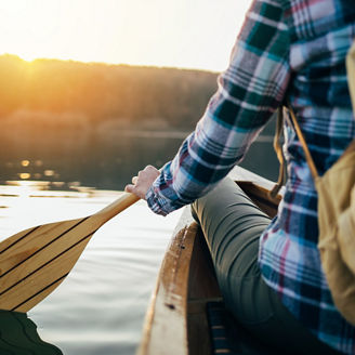 Person paddling boat in lake