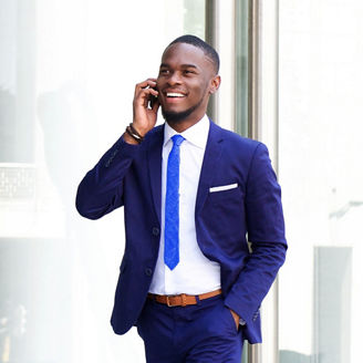 Person walking whilst holding a phone to their ear