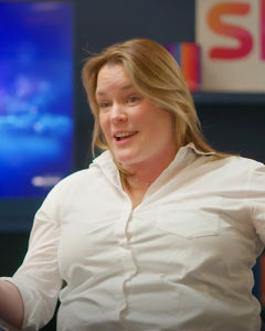 A person in a studio setting speaking with Sky logo visible in the background.