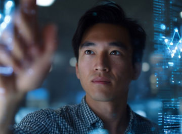 A person touching a visualisation of data in front of them