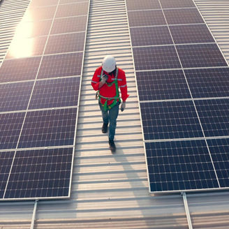 person-walking-between-solar-panels-promo