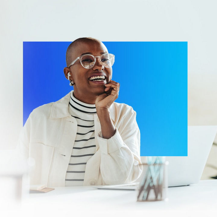 A person sat at a table with a laptop