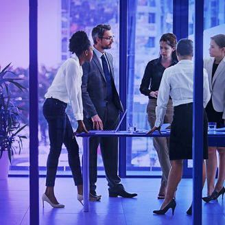 personen-stehen-um-einen-tisch