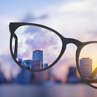 Modern bright city view through eyeglasses. Blurry background. Vision concept