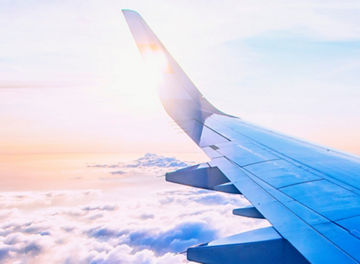 flying and traveling, view from airplane window on the wing on sunset time