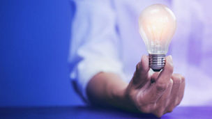 Person holding a light bulb