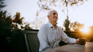 Wealthy retired businessman having a cup of coffee