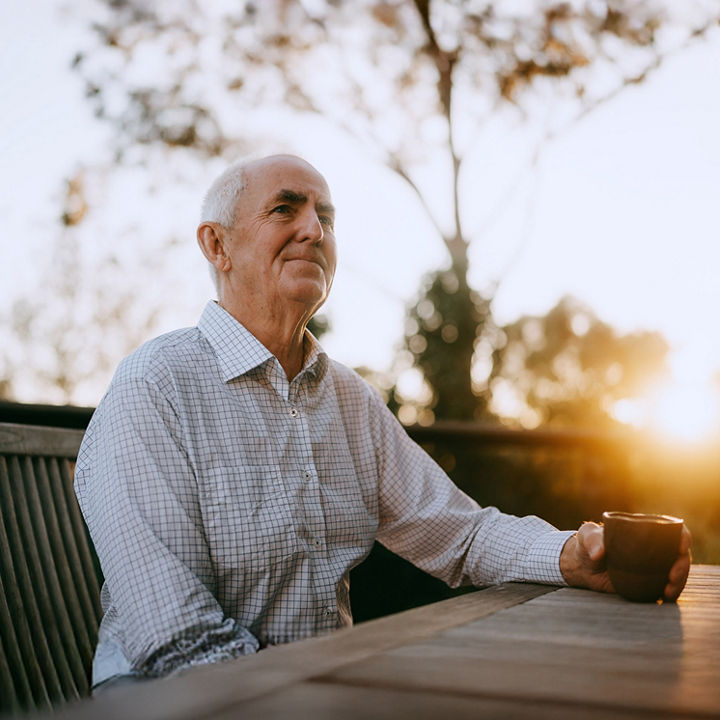 Wealthy retired businessman having a cup of coffee