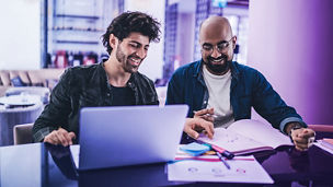 Two man working together on a laptop