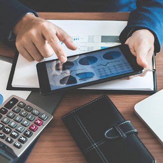 Businessman hands using text information on digital tablet to analyze financial statistical chart data and calculate cost of investment project.