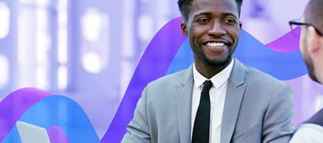 two businesswomen using laptop in boardroom