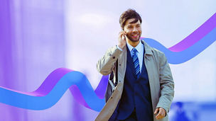 Man walking through the city while talking on his mobile phone