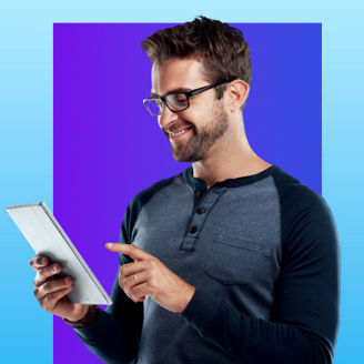 Man smiling while using a tablet