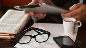 Reading news on tablet with glasses