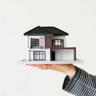 Hand presenting a house