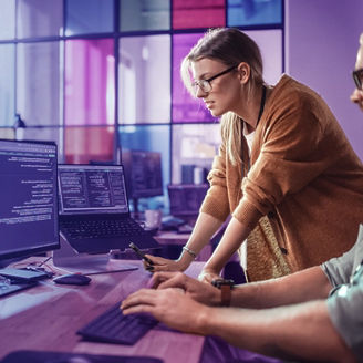 Men and woman looking at a monitor.