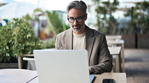 Executive looking at laptop in outdoor working space
