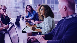 Multi-ethnic business people smiling during a meeting in conference room. Team of professionals having meeting in boardroom.; Shutterstock ID 1956492793; purchase_order: MarketingTEam Advisory Assurance; job: Anne Rouschop; client: SAP